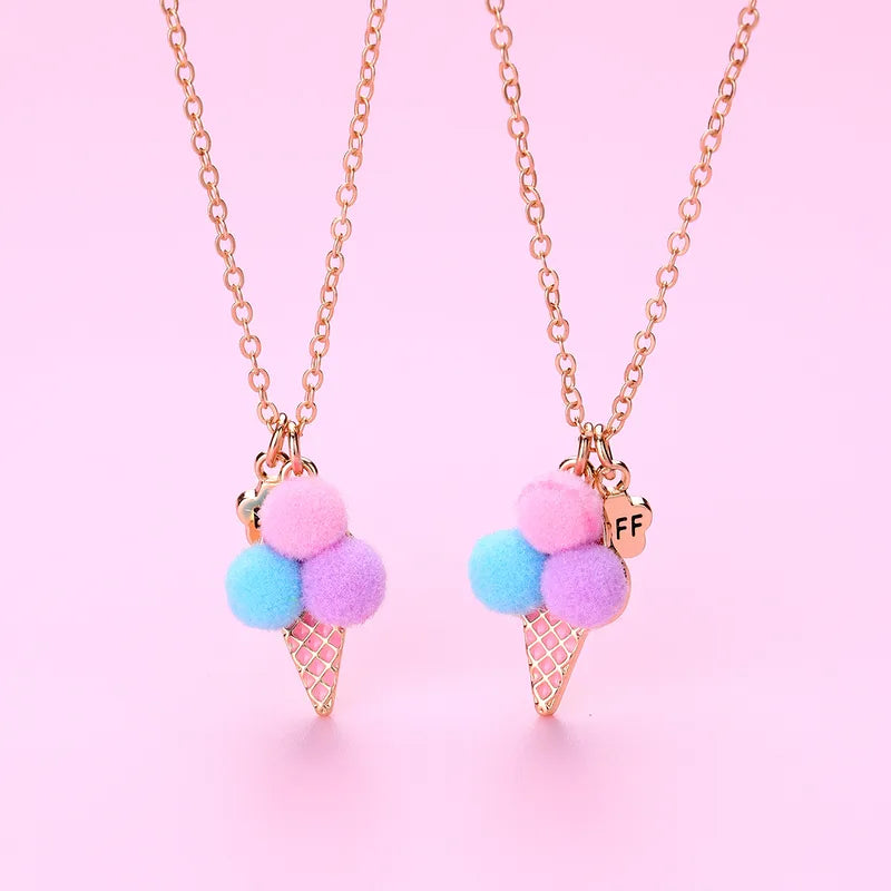 Necklace with ice cream cone pendant featuring colorful pom-poms on a pink background