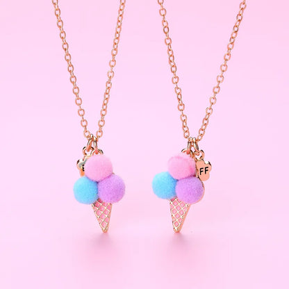 Necklace with ice cream cone pendant featuring colorful pom-poms on a pink background